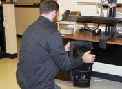 Photo of SSTS employee replacing a computer